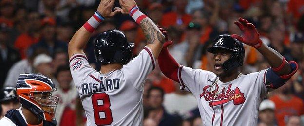 Atlanta Braves' Eddie Rosario and Jorge Soler celebrate Soler's three-run homer