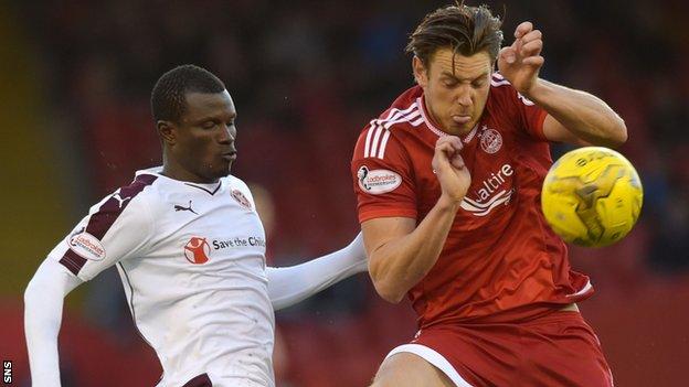 Hearts' Abiola Dauda challenges for the ball with Aberdeen's Ash Taylor