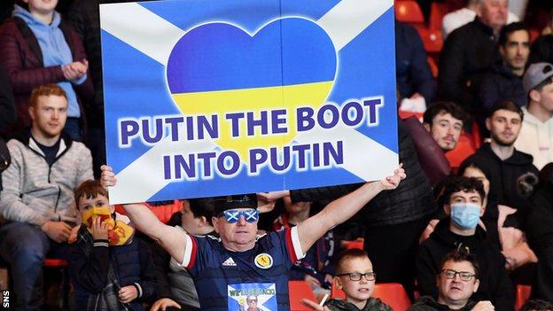 A Scotland fan with a banner backing Ukraine