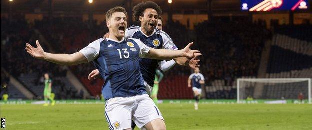 Chris Martin celebrates scoring for Scotland against Slovenia