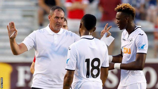 Swansea City manager Paul Clement speaks to Jordan Ayew and Tammy Abraham