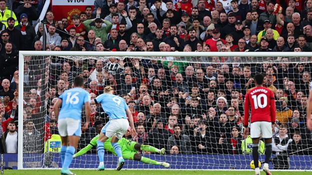 Manchester City's Erling Haaland scores from the penalty spot against Manchester United