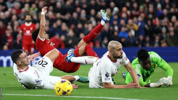 Luis Diaz of Liverpool has a shot blocked by Sofyan Amrabat and Andre Onana of Manchester United on Sunday