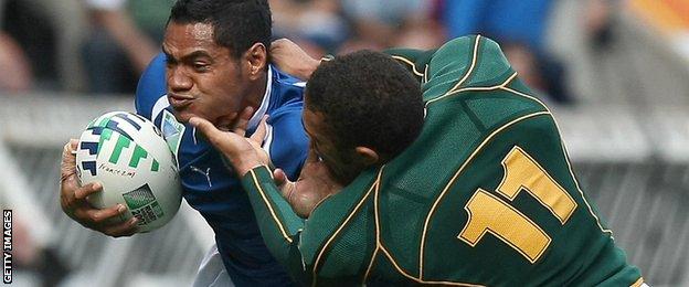 Lome Fa'atau tries to fend off Bryan Habana in a 2007 World Cup match against South Africa