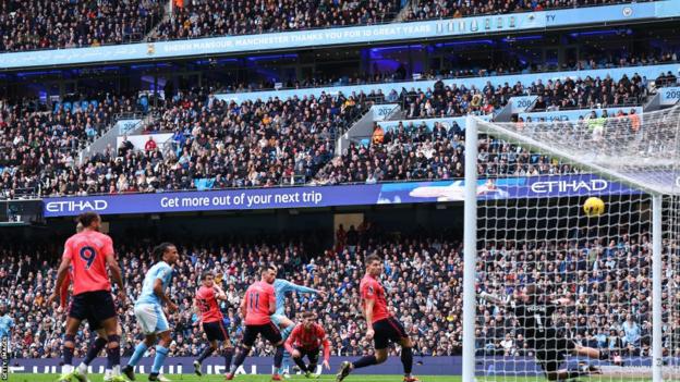 Manchester City striker Erling Haaland scores against Everton
