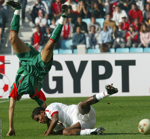Jose Clayton of Tunisia fouls Mustapha Hadji of Morocco during the Africa Cup of Nations final in 2004