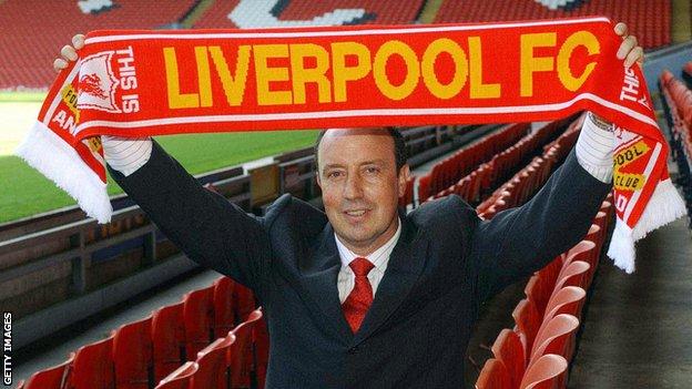 Rafael Benitez holds a scarf aloft as he is presented as Liverpool manager