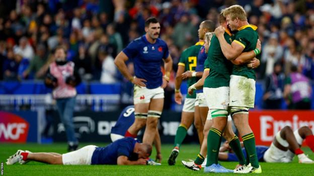 South Africa players celebrate while dejected French players lie on the ground