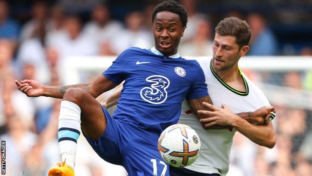 Raheem Sterling battles Tottenham's Ben Davies for the ball during their Premier League clash