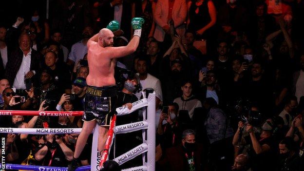 Tyson Fury jumps on the ropes to celebrate