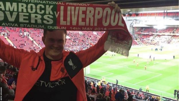 Keith Spooner pictured holding up a Shamrock Rovers v Liverpool scarf at Anfield