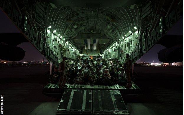 An American military plane prepares to depart Kabul airport carrying evacuees, on 21 August