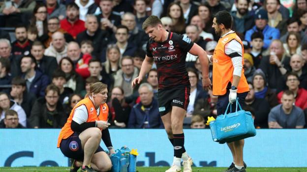 Owen Farrell of Saracens leaves the field with an injury