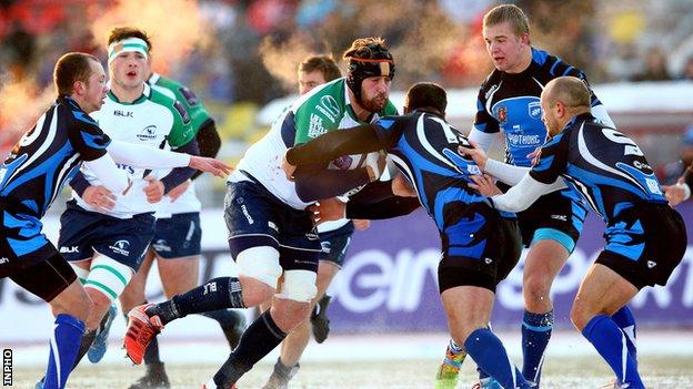 Connacht's Aly Muldowney is tackled by Ramil Gaisin and David Kacharava in Russia