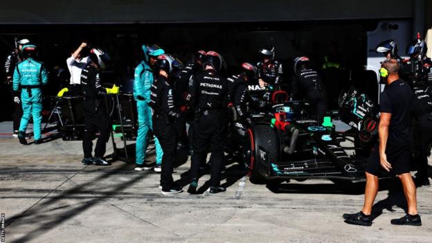 Mercedes' George Russell drives into the pit garage to retire from the Sao Paulo Grand Prix