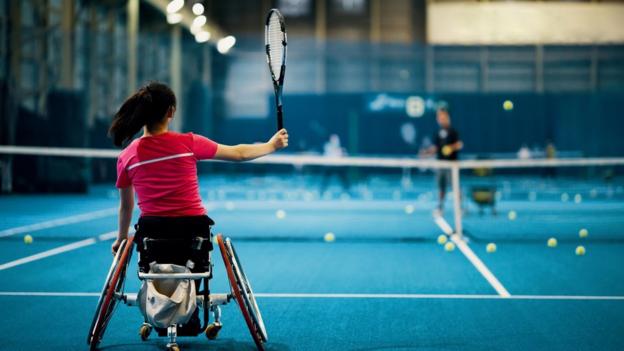 Wheelchair tennis player plays a forehand shot