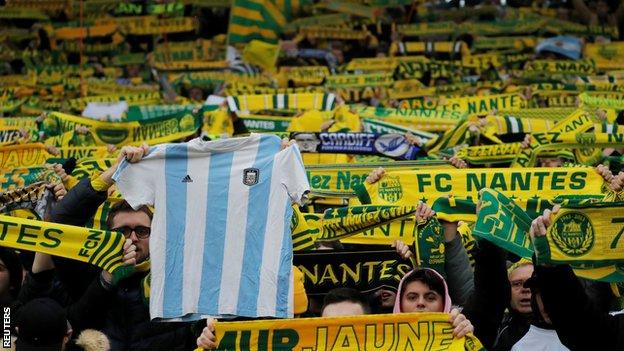 A Nantes fan holds up an Argentina shirt inside the Stade de la Beaujoire