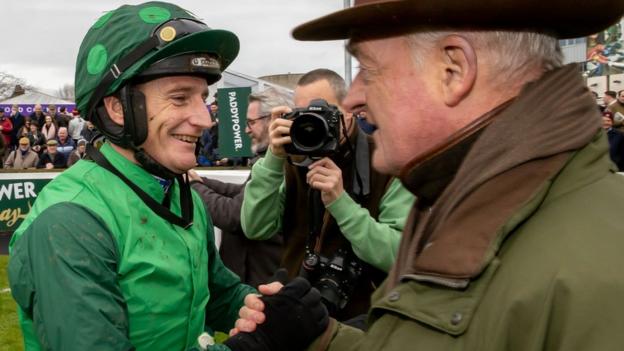 Daryl Jacob and trainer celebrate Willie Mullins celebrate winning the Paddy's Rewards Club Chase