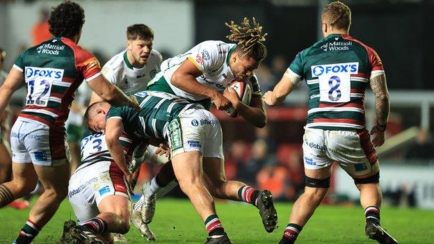 Chandler Cunningham-South of London Irish is tackled during the Premiership Rugby Cup match between Leicester Tigers and London Irish