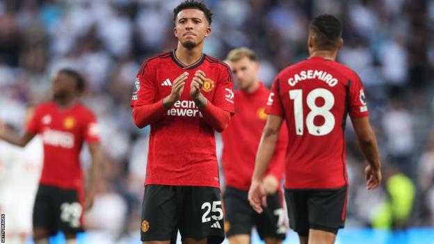 Jadon Sancho applauds the fans at the end of a Manchester United game