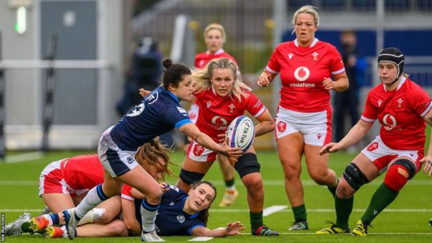 Caity Mattison of Scotland juggles the ball as she is tracked by Alex Callender