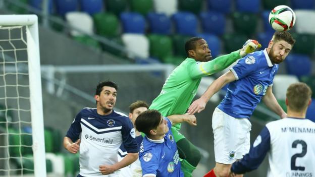 Ballinamallard United keeper Alvin Rouse is beaten to the high ball by Linfield defender Mark Stafford at Windsor Park