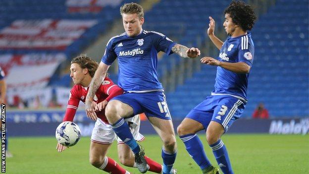 Cardiff's Aron Gunnarson (centre) and Fabio (right) challenge Bristol City's Luke Freeman (left)