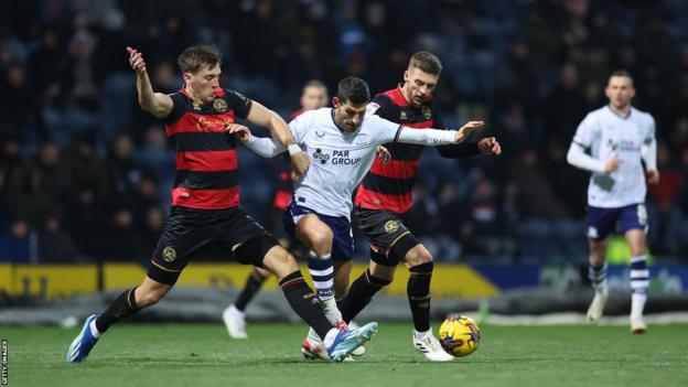 Preston's Ched Evans (centre) taking on the Queens Park Ranger defence in the Championship
