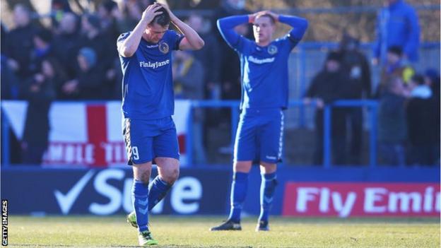 Curzon Ashton's players react after conceding a goal against AFC Wimbledon in the FA Cup