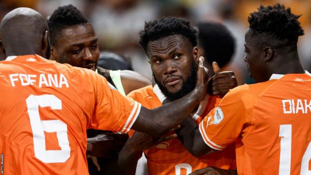 Ivory Coast midfielder Franck Kessie celebrates with forward Christian Kouame after scoring his team's first goal from the penalty spot during the Africa Cup of Nations (Afcon) 2023 round of 16 football match between Senegal and Ivory Coast at the Stade Charles Konan Banny in Yamoussoukro