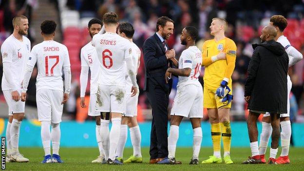 Gareth Southgate (centre in the suit) with England players