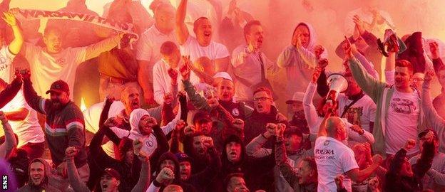 Legia fans let of flares during the second half at Ibrox