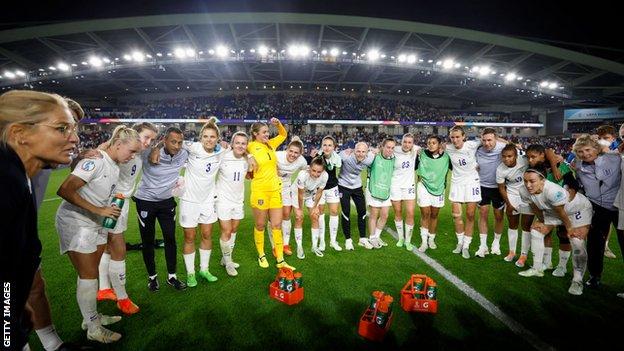 Sarina Wiegman talks to the England players after their win over Spain
