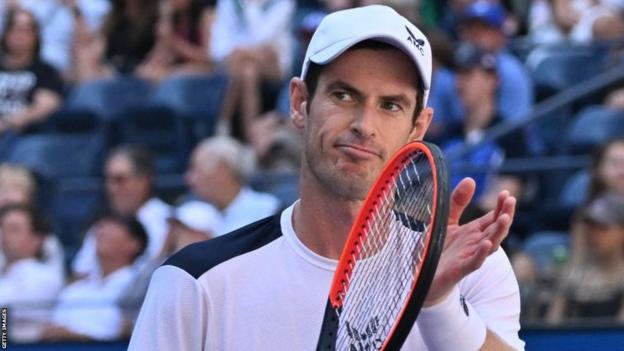 Andy Murray sarcastically cheers his racquet towards his team