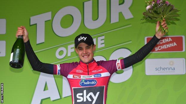 Team Sky's Pavel Sivakov holds up champagne and flowers on the podium after winning stage two of the Tour of the Alps