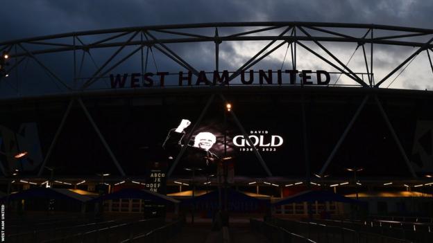 An image of David Gold is projected onto the side of West Ham's London Stadium following the co-chairman's death at 86