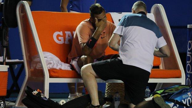Nick Kyrgios looking dejected while receiving treatment on his left wrist during a medical timeout at the Mexican Open
