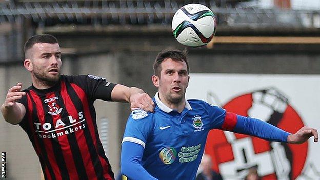 Crusaders defender Colin Coates battles with Linfield's Andrew Waterworth during the last game between the clubs in April