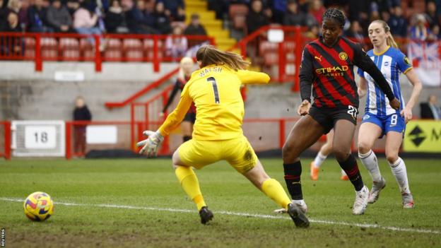Manchester City's Khadija Shaw puts her first goal past Brighton & Hove Albion's Megan Walsh in WSL