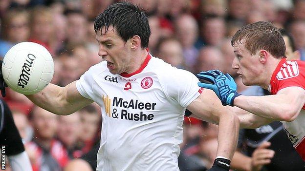 Tyrone's Mattie Donnelly in action against Brendan Rogers of Derry