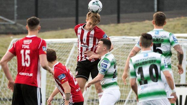 Candystripes midfielder Greg Sloggett rises highest to head clear against the leaders