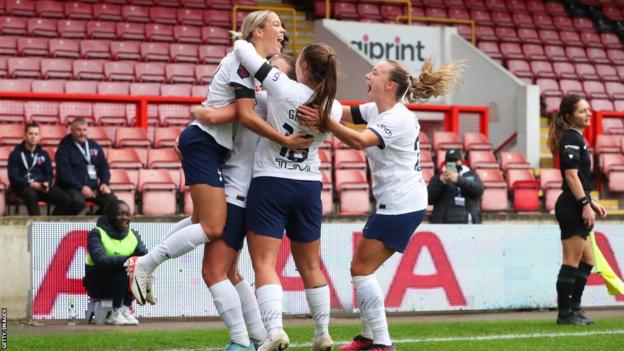 Celin Bizet celebrates with team-mates after scoring for Tottenham against Liverpool in the WSL