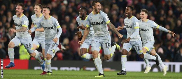 Derby's players rush to acclaim their penalty shoot-out win against Manchester United