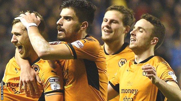 Barry Douglas celebrates with this Wolves team-mates after scoring their second goal against Brentford in the Championship