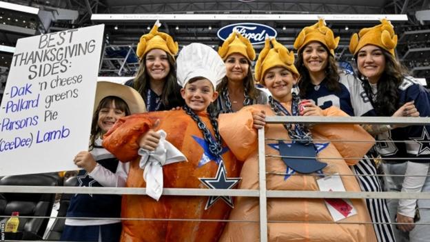 Fans wearing turkey hats at the Dallas Cowboys' 2023 Thanksgiving game