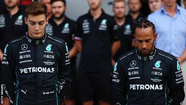 George Russell and Lewis Hamilton bow their heads