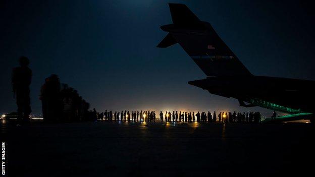 An air crew prepares to load evacuees at Kabul airport in August 2021