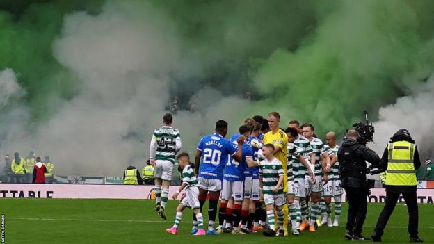 Celtic fans set off flares in the stands as they wait for the players to perform the pre-match handshake.