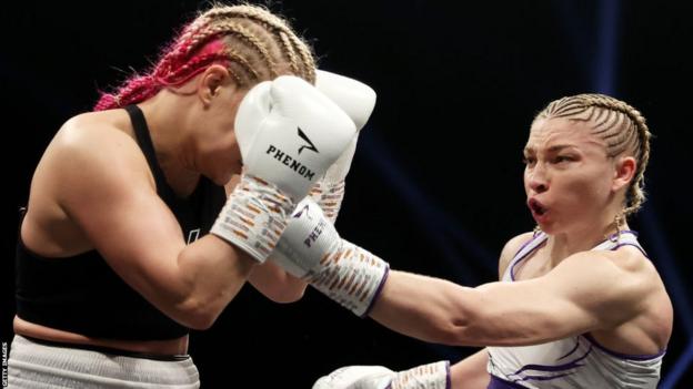 Lauren Price punches Valgerdur Gudstensdottir during the Welterweight fight