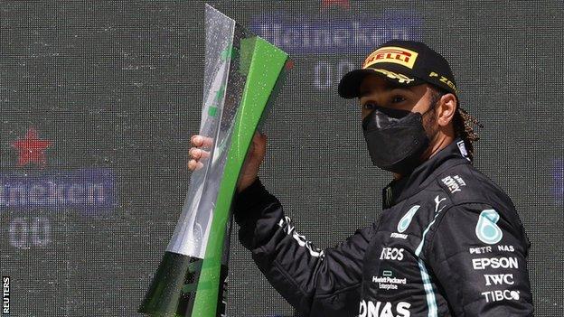 Lewis Hamilton celebrates on the podium after winning the Portuguese Grand Prix